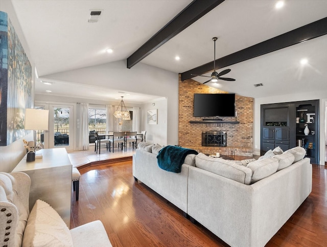 living room featuring lofted ceiling with beams, ceiling fan, a fireplace, and dark hardwood / wood-style flooring