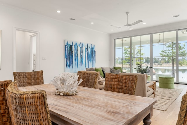 dining space with ceiling fan and light hardwood / wood-style flooring