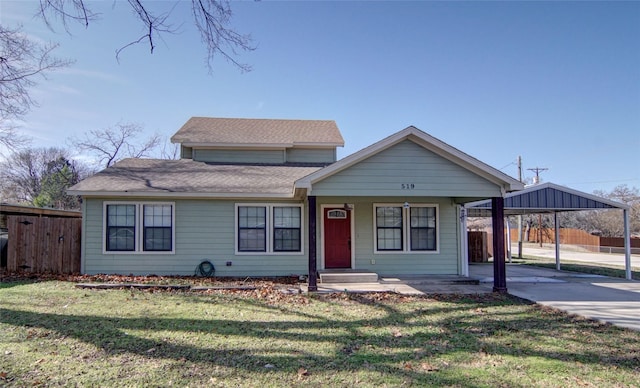 view of front of house with a front lawn and a carport