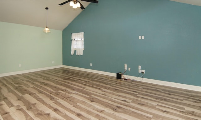 unfurnished room featuring hardwood / wood-style flooring, ceiling fan, and high vaulted ceiling