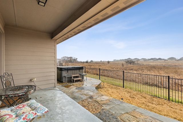 view of patio / terrace featuring a mountain view and a hot tub