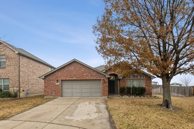 view of front of house with a garage and a front lawn