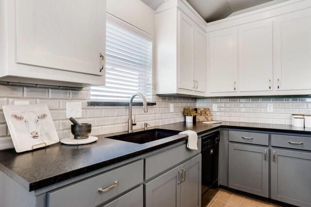 kitchen with tasteful backsplash, gray cabinets, black appliances, and white cabinets