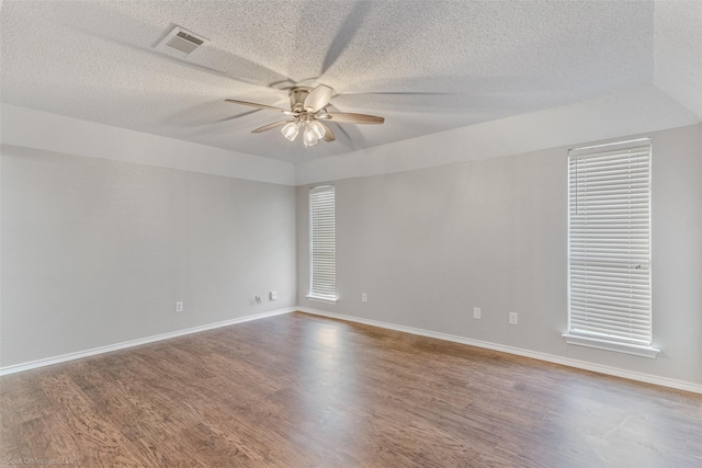 unfurnished room featuring wood-type flooring, a textured ceiling, and ceiling fan