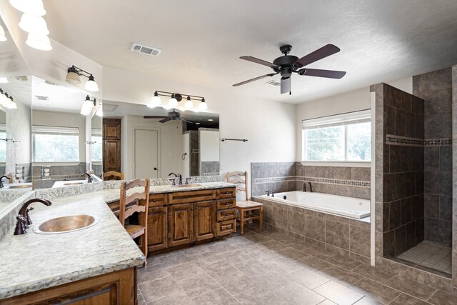 bathroom featuring independent shower and bath, vanity, and ceiling fan