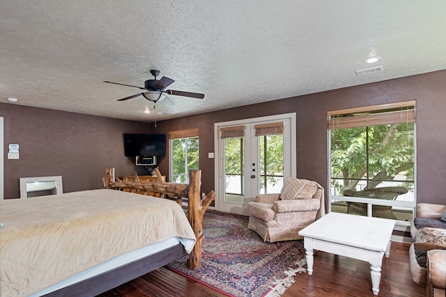 bedroom featuring french doors, wood finished floors, visible vents, and access to exterior