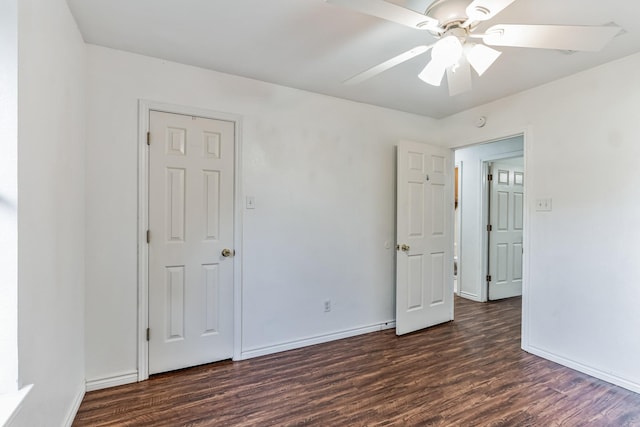 spare room featuring dark hardwood / wood-style floors and ceiling fan