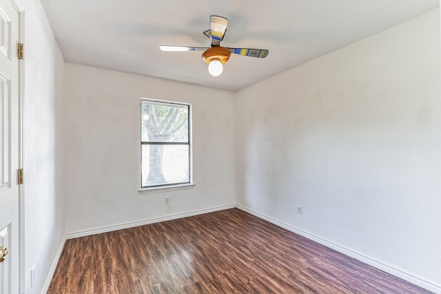 empty room with dark wood-type flooring and ceiling fan