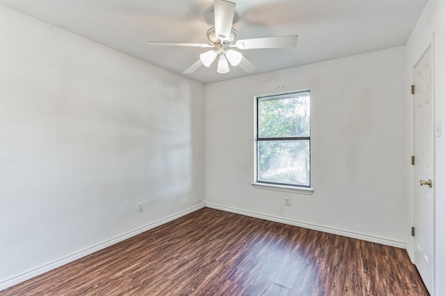 empty room with dark hardwood / wood-style floors and ceiling fan