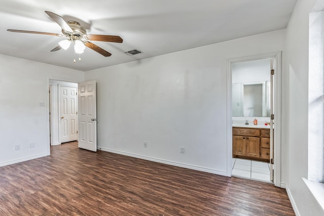 128 Black Forest Dr, Weatherford, TX 76086 - unfurnished bedroom featuring a sink, ensuite bathroom, baseboards, visible vents, and dark wood-type flooring