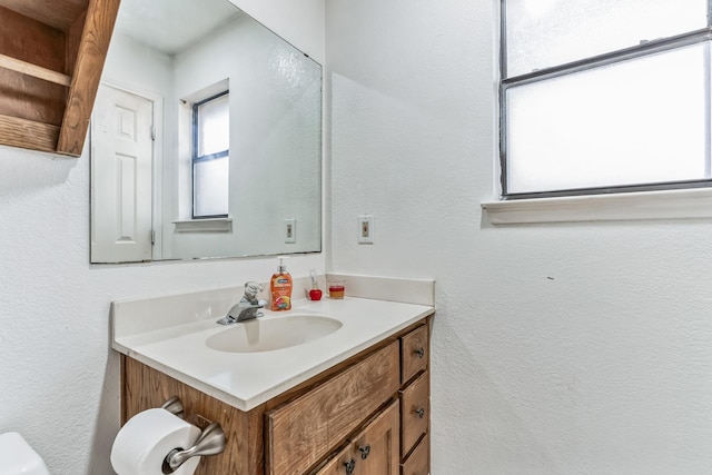 128 Black Forest Dr, Weatherford, TX 76086 - bathroom featuring toilet, vanity, and a textured wall