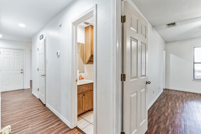 corridor featuring hardwood / wood-style floors