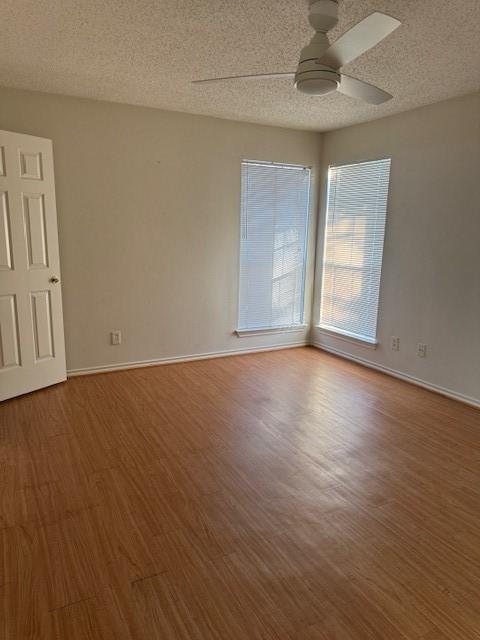 unfurnished room featuring hardwood / wood-style floors, a textured ceiling, and ceiling fan