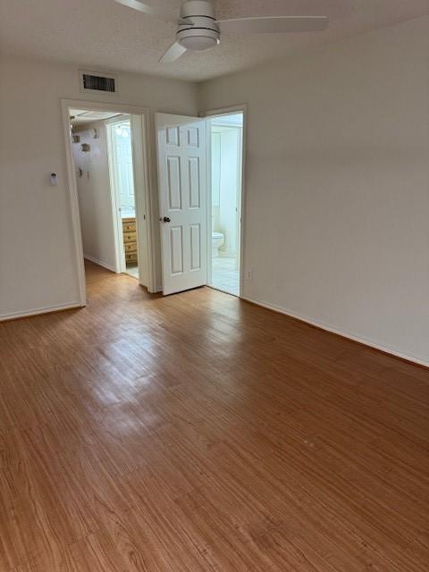 unfurnished room with hardwood / wood-style flooring and ceiling fan