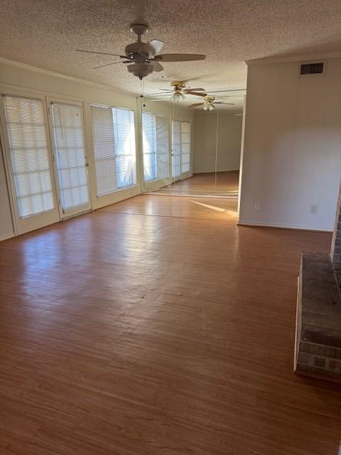 spare room with ornamental molding, dark hardwood / wood-style floors, ceiling fan, and a textured ceiling