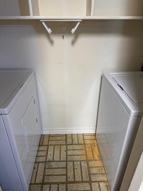 clothes washing area featuring independent washer and dryer