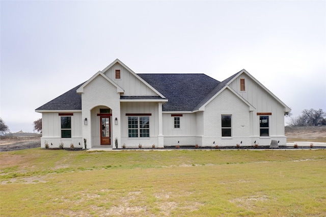 modern inspired farmhouse with a front lawn