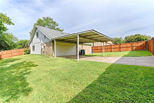 view of yard with a carport and central air condition unit