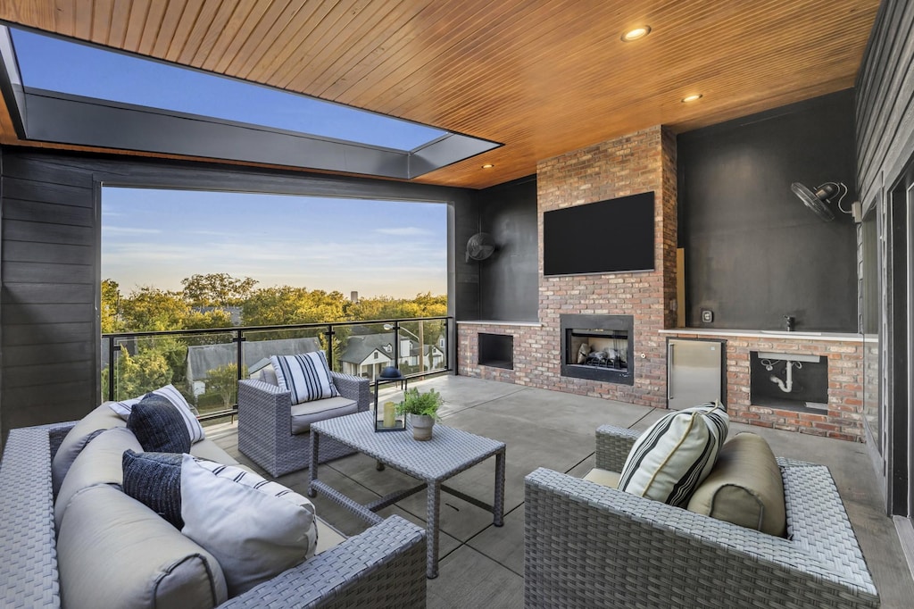 view of patio / terrace with an outdoor living space with a fireplace