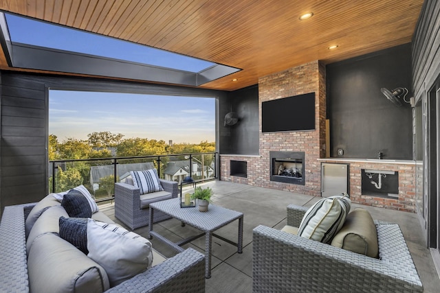 view of patio / terrace with an outdoor living space with a fireplace