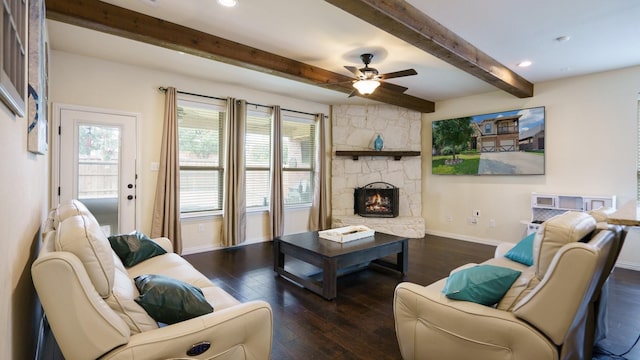 living room with a stone fireplace, a wealth of natural light, and dark wood-type flooring