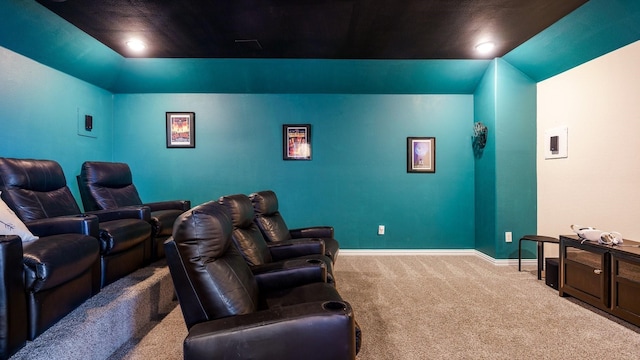 carpeted home theater room featuring vaulted ceiling