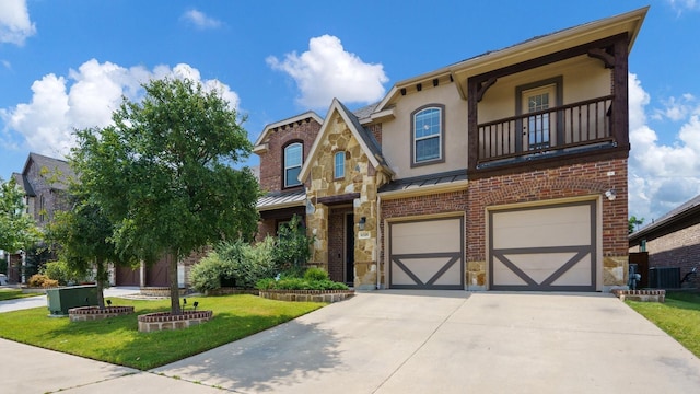 view of front of house featuring a garage, a balcony, cooling unit, and a front yard