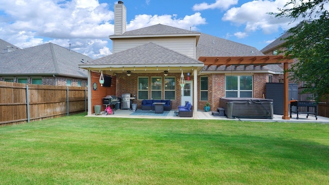 rear view of house featuring a patio area, a hot tub, a lawn, a pergola, and an outdoor hangout area