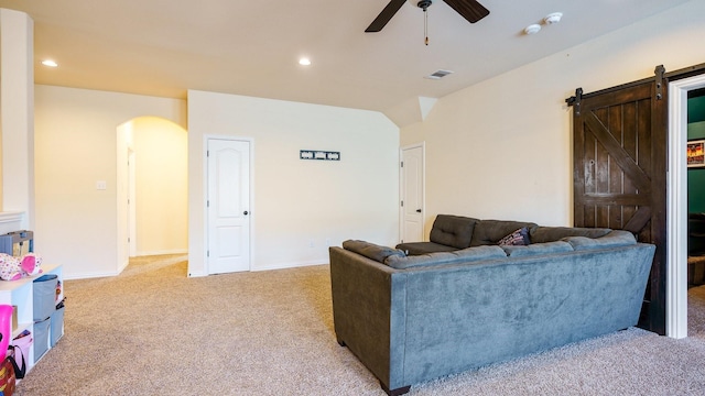 carpeted living room featuring lofted ceiling, a barn door, and ceiling fan