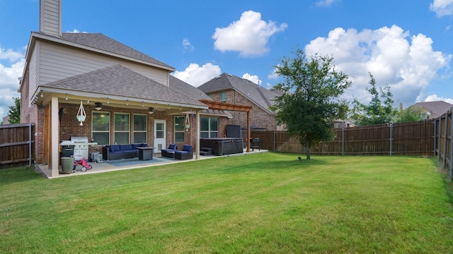 back of property featuring a lawn, a pergola, outdoor lounge area, a patio area, and a hot tub