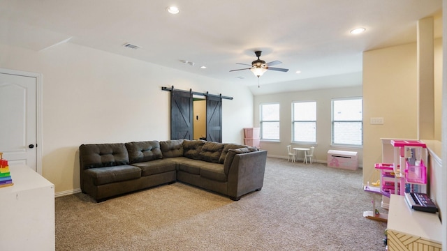 carpeted living room featuring a barn door and ceiling fan