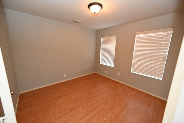 unfurnished room with hardwood / wood-style floors