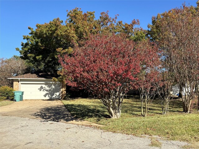 obstructed view of property with a garage