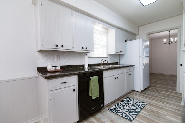 kitchen with sink, white cabinetry, hanging light fixtures, light wood-type flooring, and black dishwasher