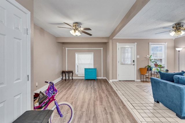 entrance foyer with ceiling fan and light hardwood / wood-style flooring