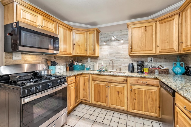 kitchen with sink, light tile patterned floors, stainless steel appliances, light stone countertops, and decorative backsplash