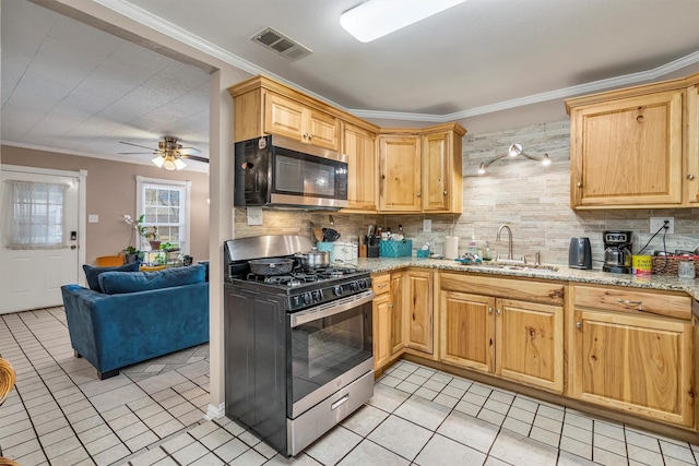 kitchen with crown molding, appliances with stainless steel finishes, and sink