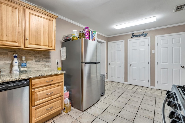 kitchen with light stone counters, ornamental molding, appliances with stainless steel finishes, and light tile patterned floors