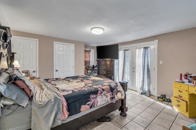 bedroom featuring access to outside, french doors, and light tile patterned flooring