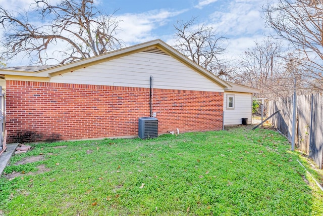 exterior space featuring a yard and central AC