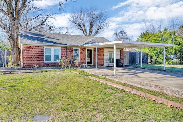 single story home featuring a front lawn and a carport