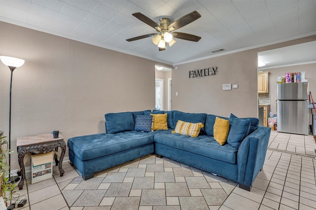 living room featuring crown molding, ceiling fan, and light tile patterned flooring