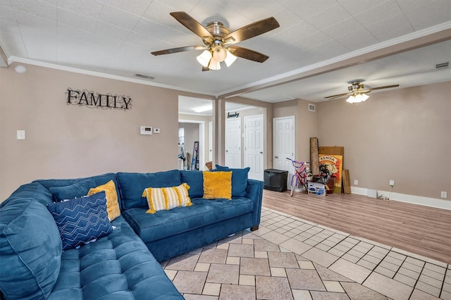 living room featuring light hardwood / wood-style flooring, ornamental molding, and ceiling fan