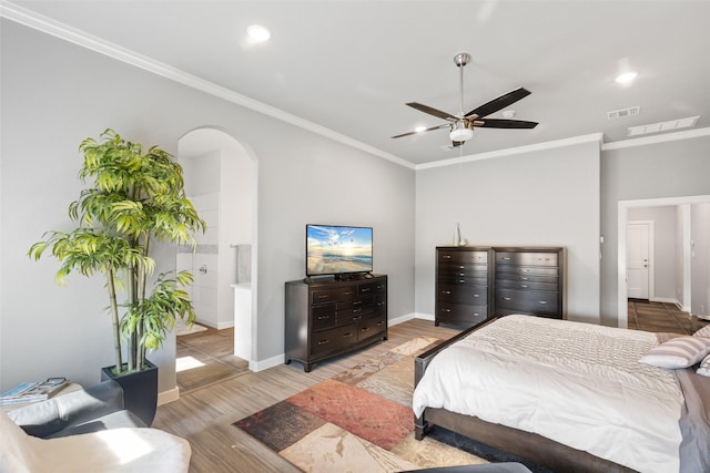 bedroom with hardwood / wood-style flooring, ceiling fan, ornamental molding, and ensuite bath