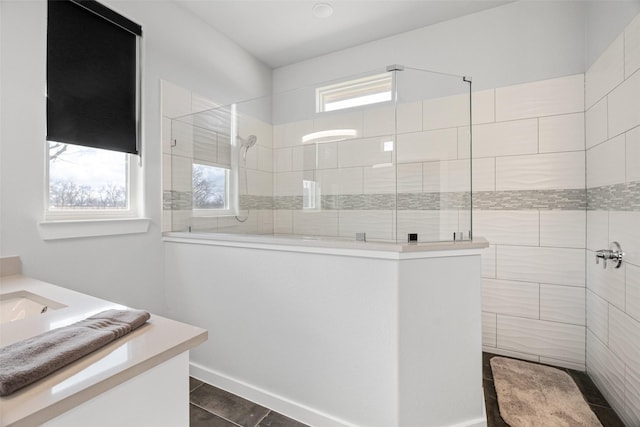 bathroom with vanity and tiled shower