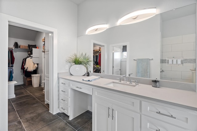 bathroom with tile patterned floors, vanity, and a shower with door