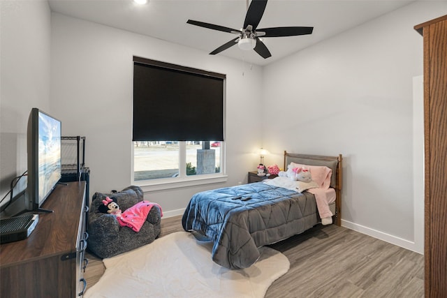 bedroom with hardwood / wood-style flooring and ceiling fan