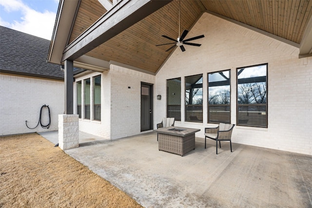 view of patio / terrace featuring ceiling fan and a fire pit