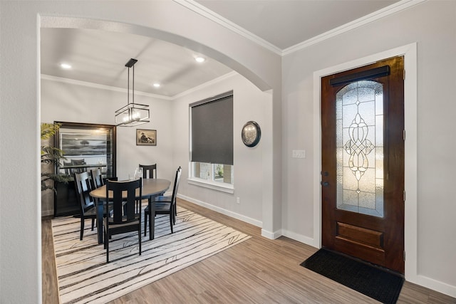 entryway featuring ornamental molding and light wood-type flooring