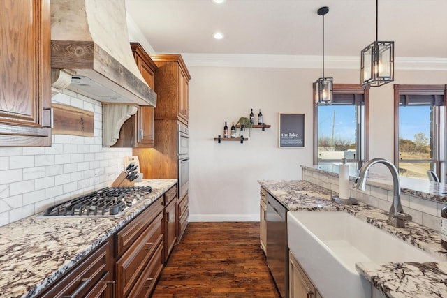 kitchen with sink, decorative light fixtures, ornamental molding, dark hardwood / wood-style floors, and stainless steel appliances